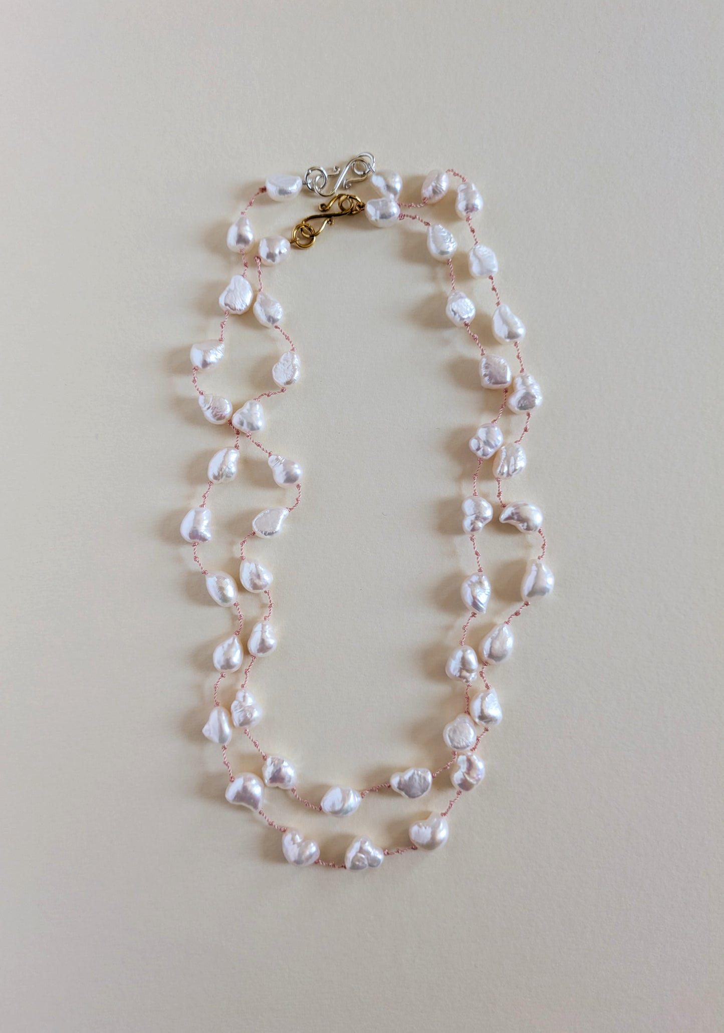 Pearl necklace on a light beige background and its varaint.