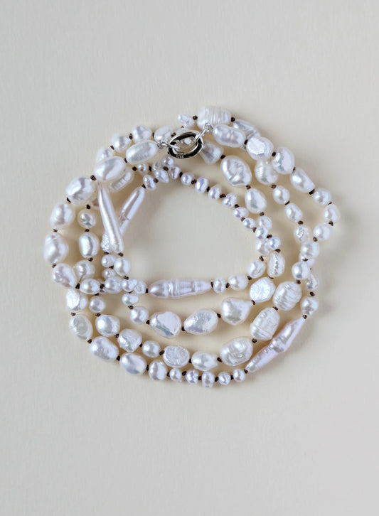 Pearl necklace on a beige background