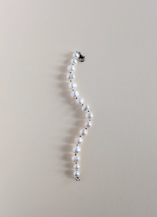 Pearl necklace on a beige background