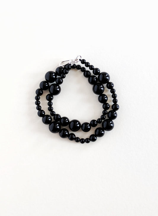 Black beaded bracelet on a white background