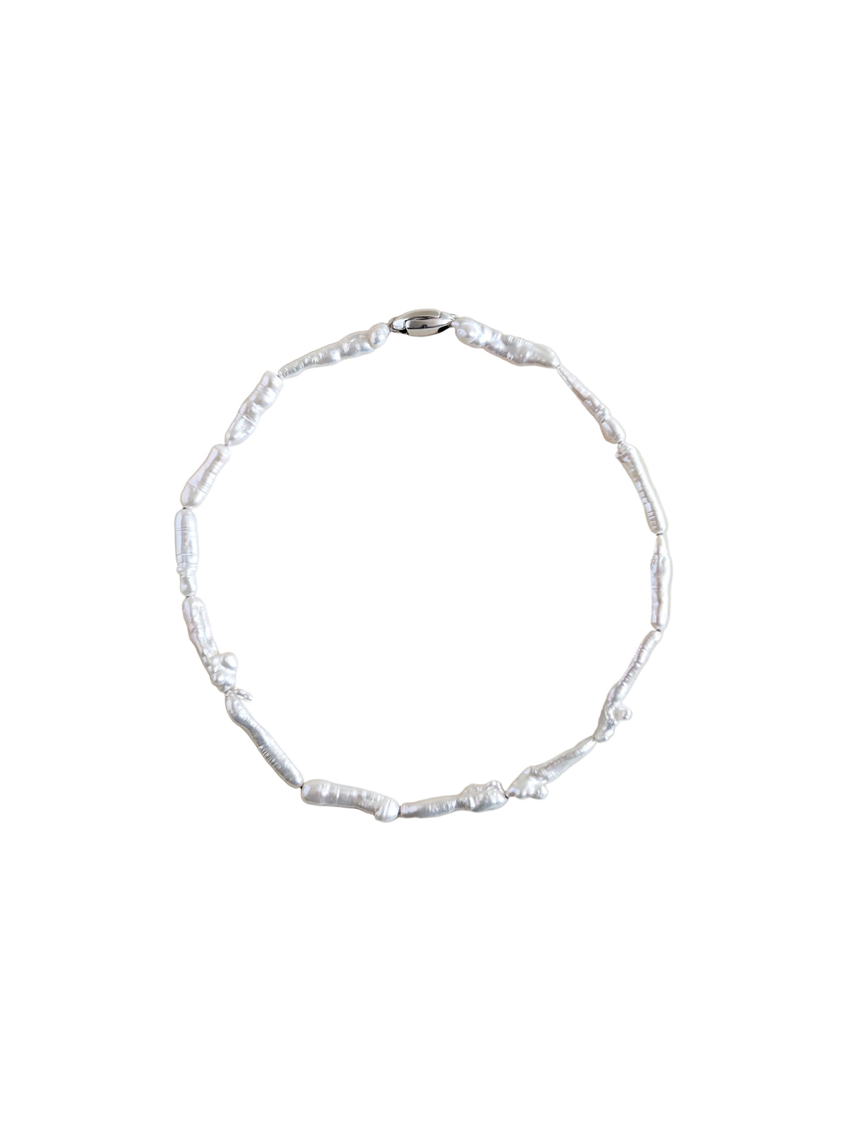 A pearl choker made of irregular keshi biwa pearls on a plain beige background.