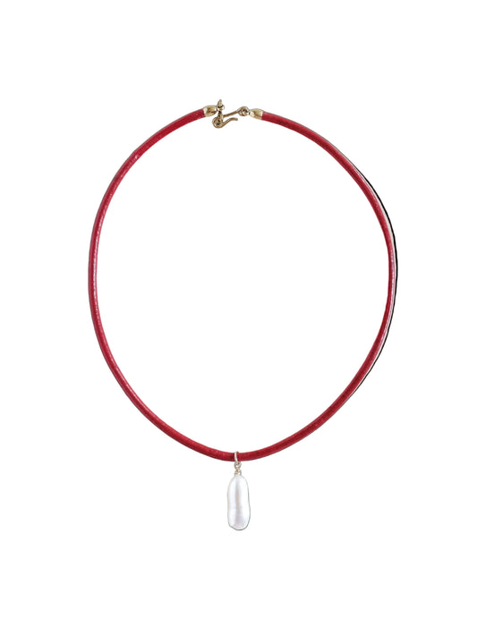 Red necklace with a white pendant on a light gray background