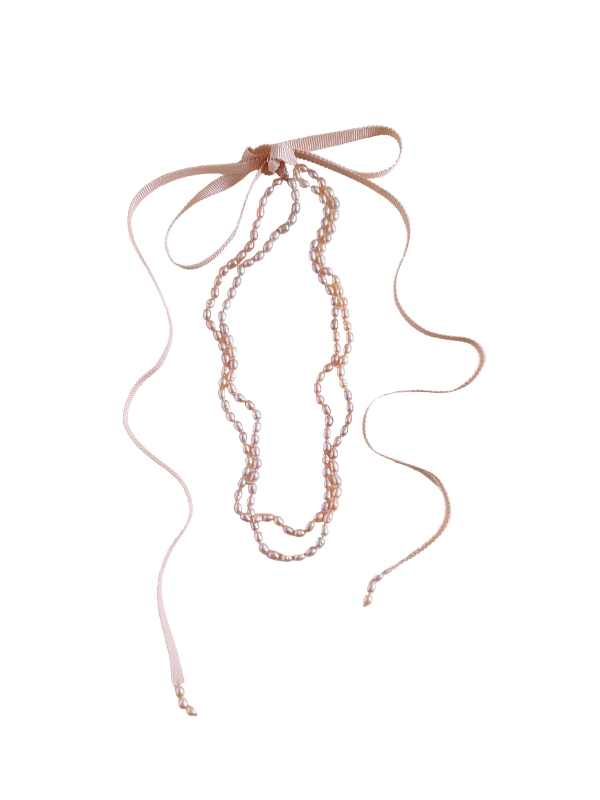 Long necklace with pink beads on a white background