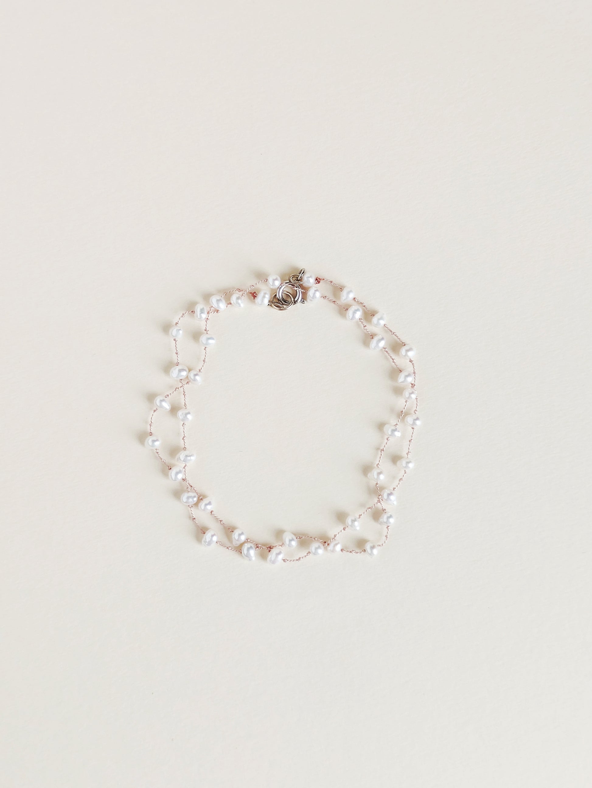 Pearl bracelet on a light beige background