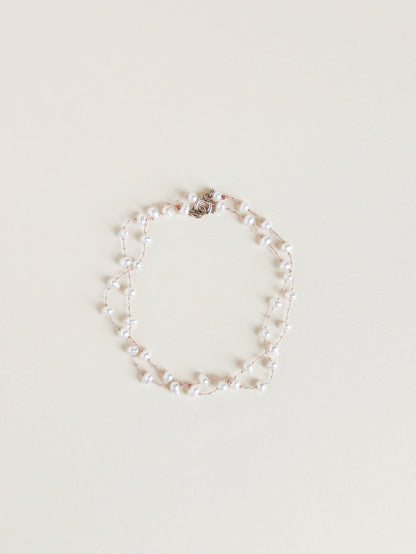 Pearl bracelet on a light beige background