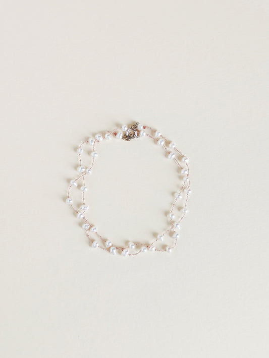 Pearl bracelet on a light beige background