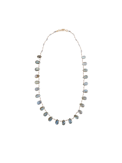 A delicate necklace featuring labradorite teardrop beads against a  solid off-white background.