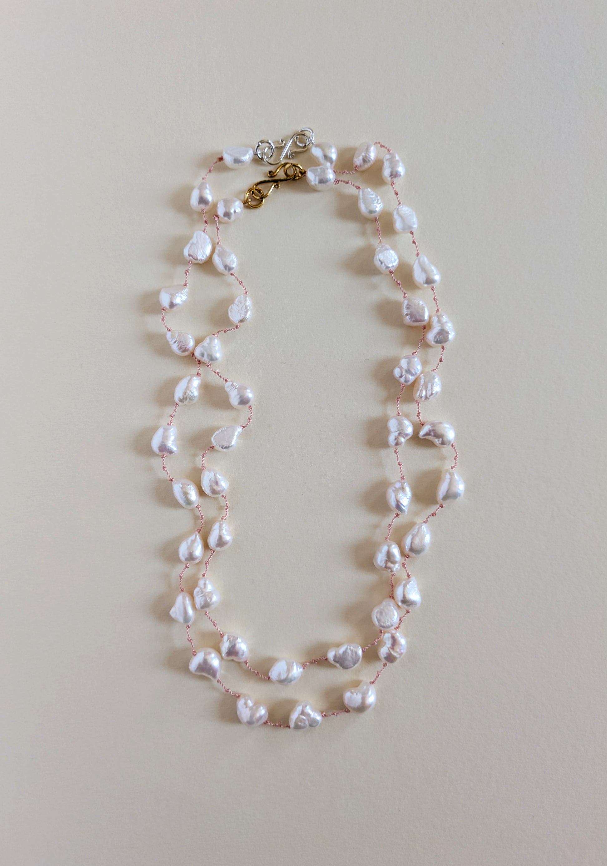 Pearl necklace on a light beige background and its varaint.