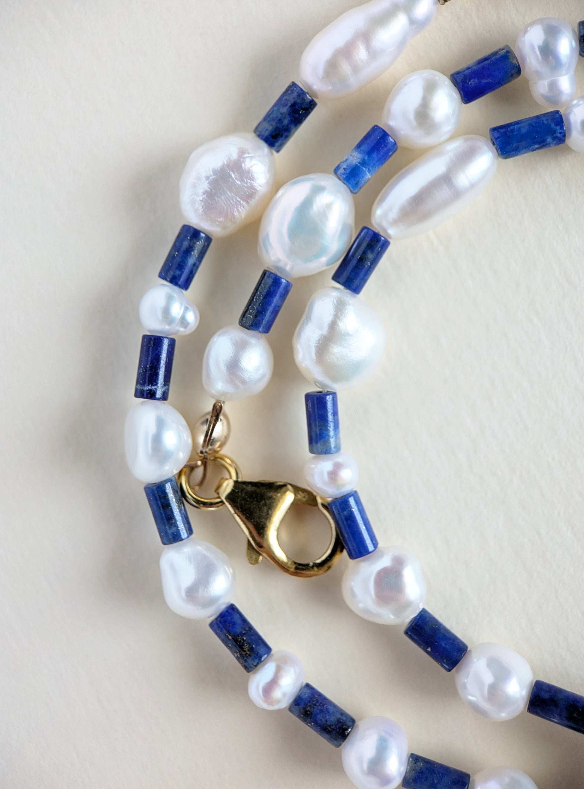 Details of lapis lazuli and pearl choker.