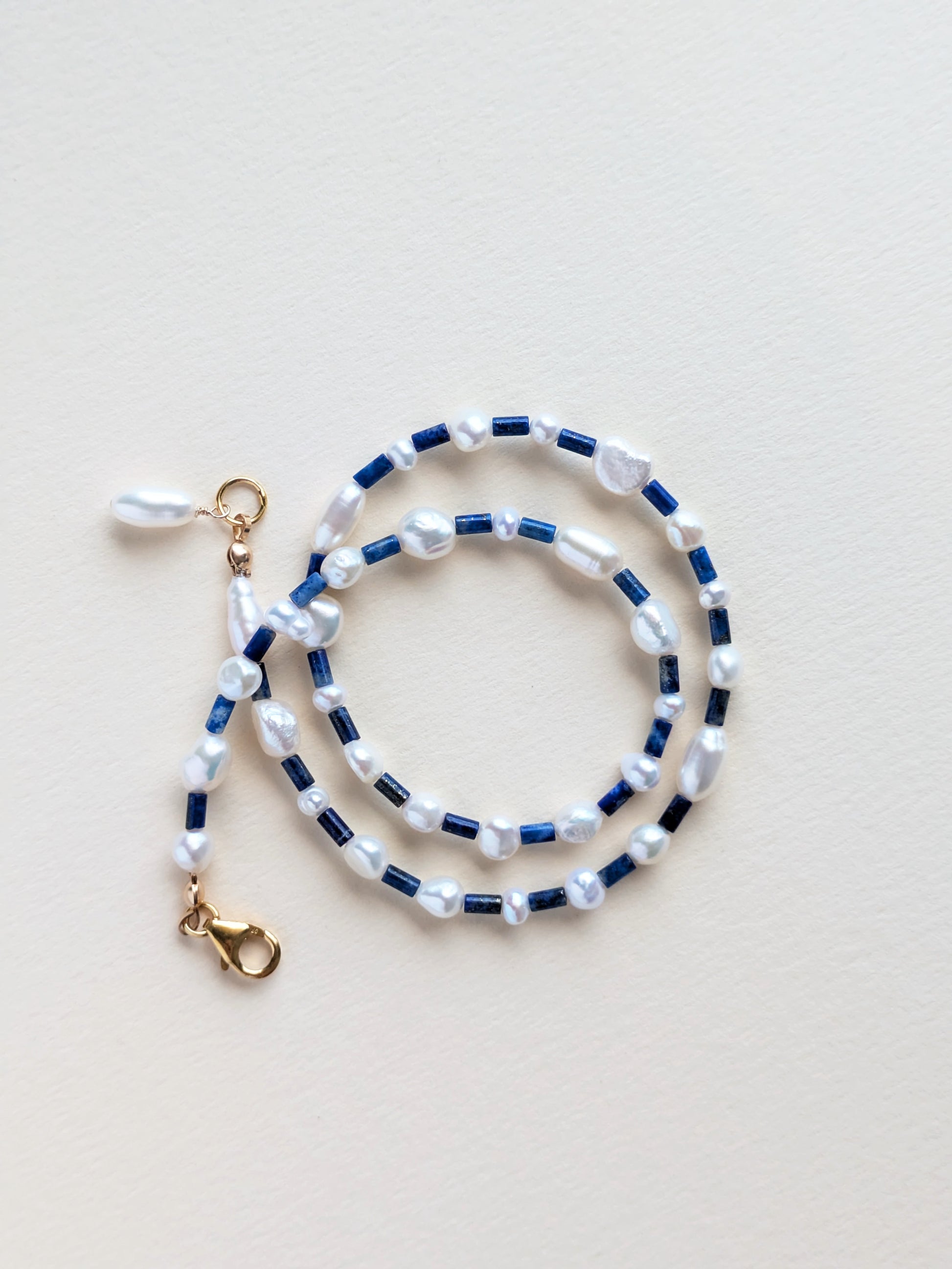 Lapis lazuli in pearl choker, wrapped.