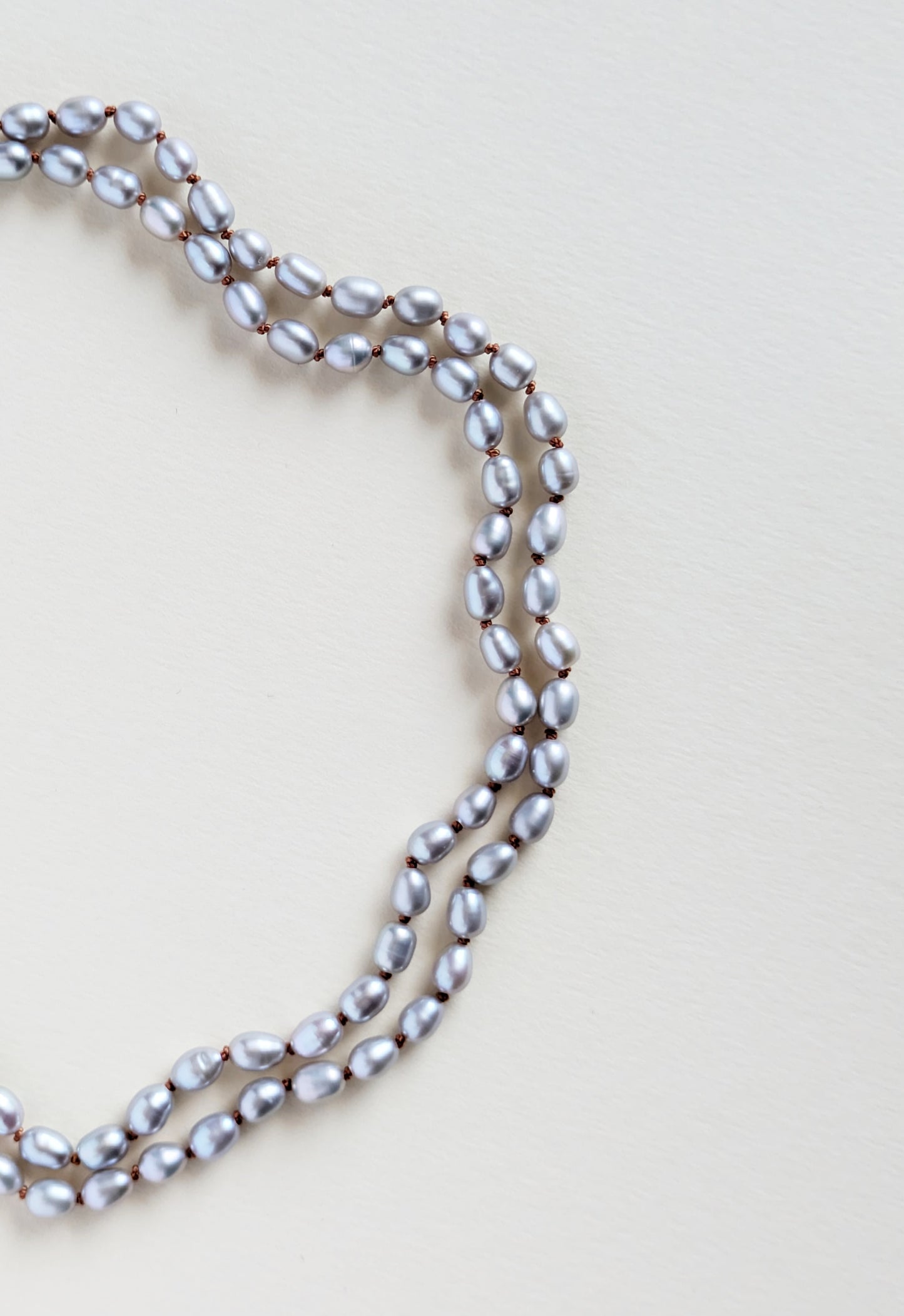 Pearl necklace on a light beige background