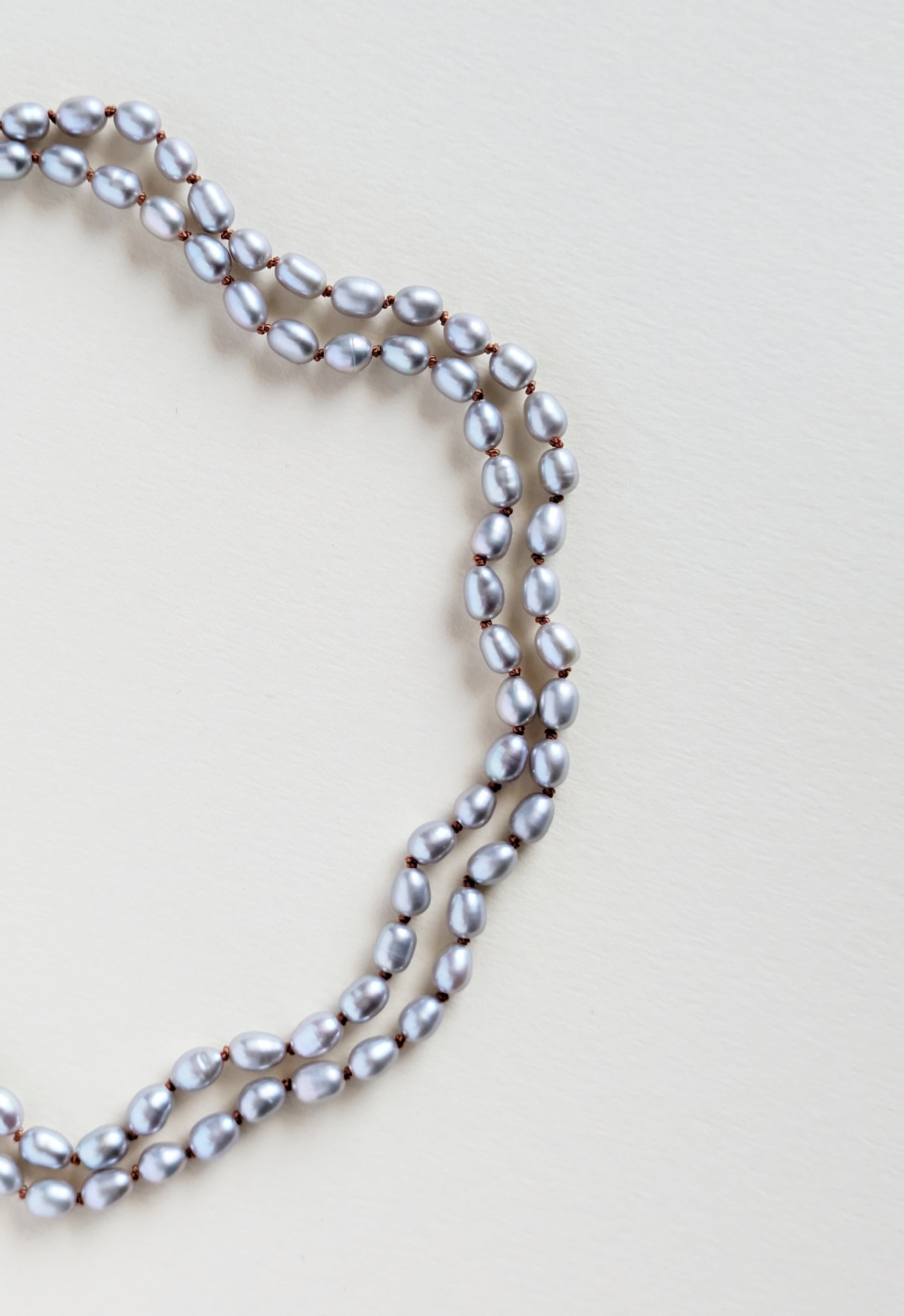 Pearl necklace on a light beige background