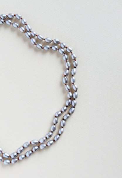 Pearl necklace on a light beige background