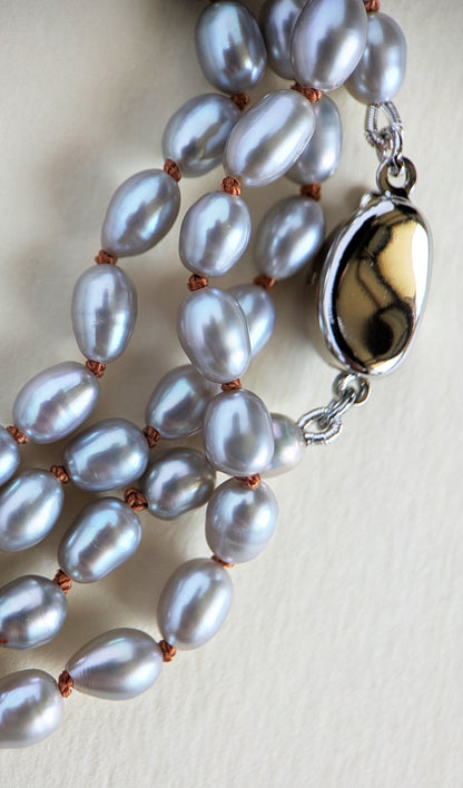 Detail of a grey rice pearl necklace and silver clasp