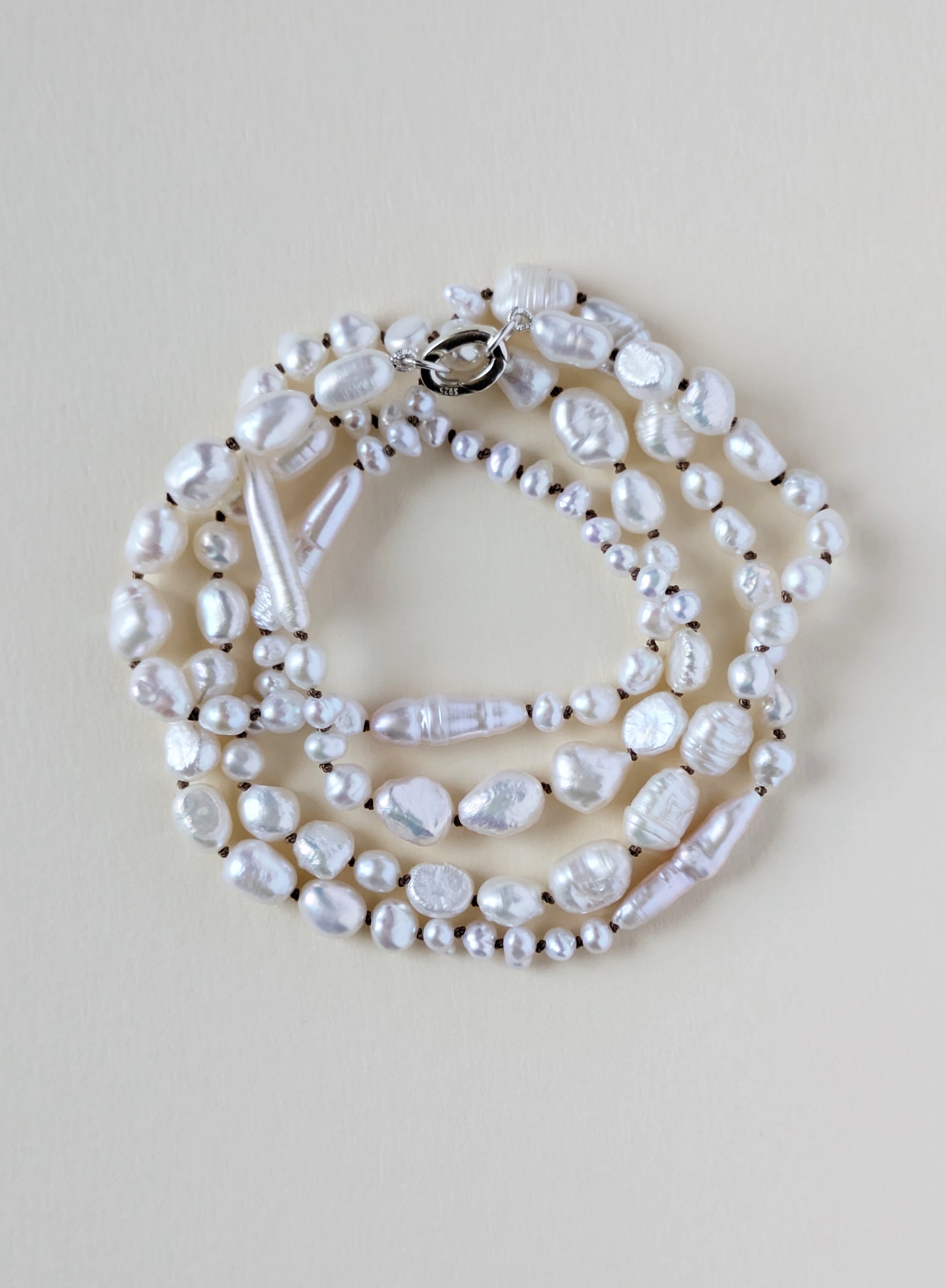 Pearl necklace on a beige background