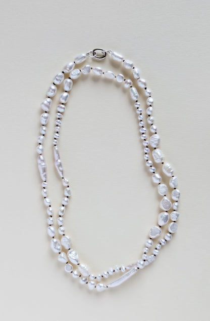 Pearl necklace on a light beige background