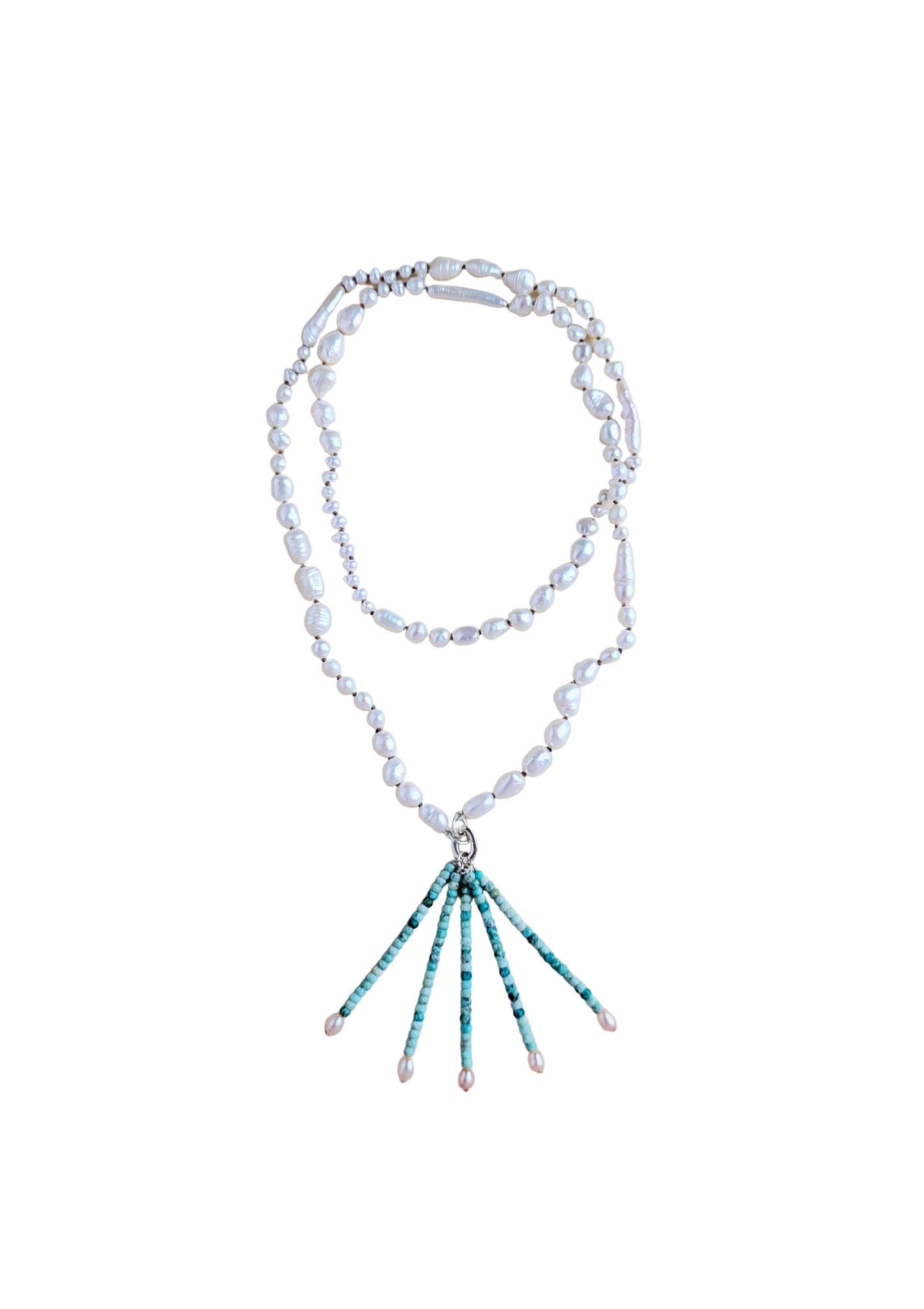 A double-strand necklace featuring irregular white freshwater pearls and a silver-tone clasp, with a drop pendant composed of turquoise and white beads ending in small pearl tips, displayed on a neutral beige background.