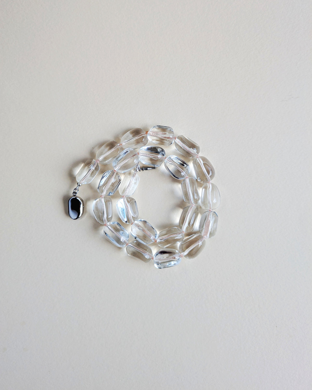 Lucite bead necklace with a silver clasp.