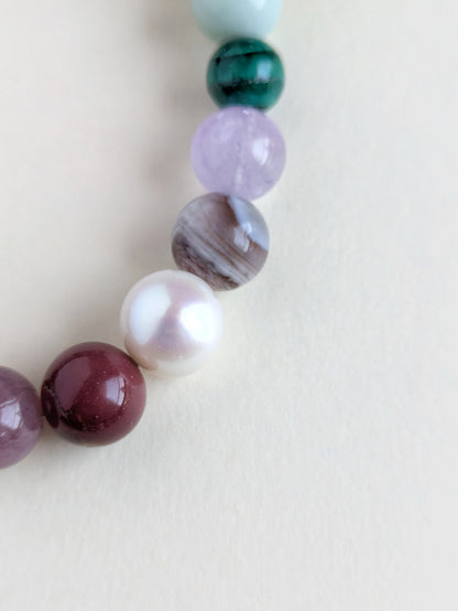 Close-up of the colorful gemstone beads on a beige background.