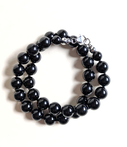 Black onyx beaded necklace wrapped as a bracelet.
