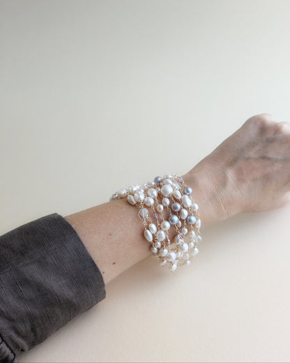 Multi-strand freshwater pearl bracelet with nine wire-looped pearl strands and a magnetic clasp