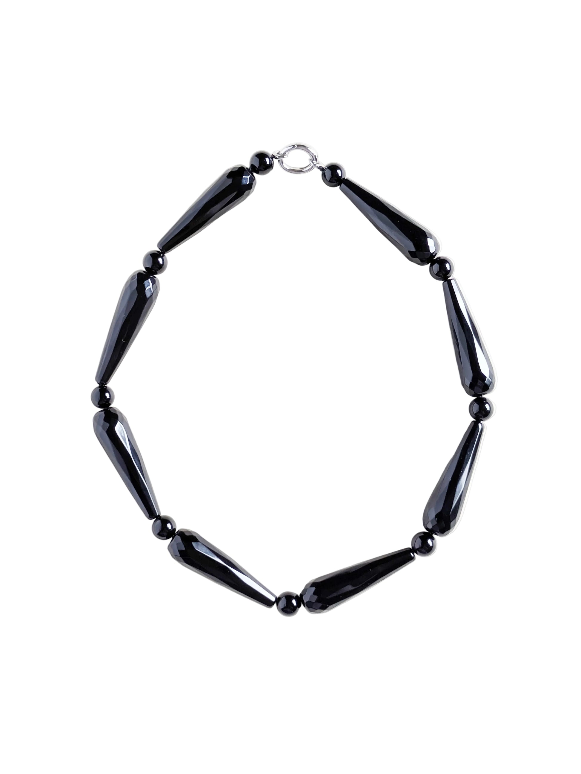 Onyx necklace Drama on a white surface.
