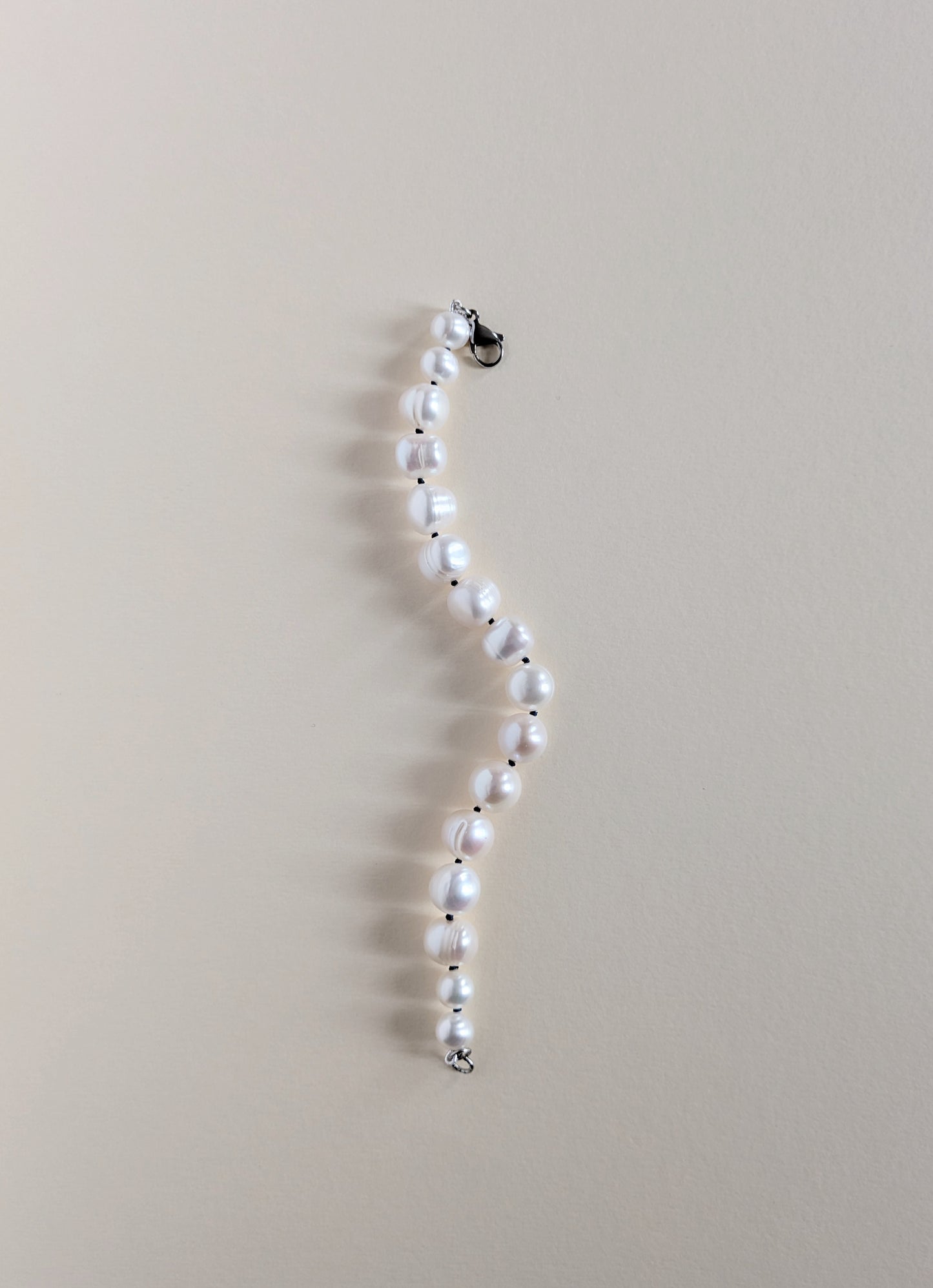Pearl necklace on a beige background