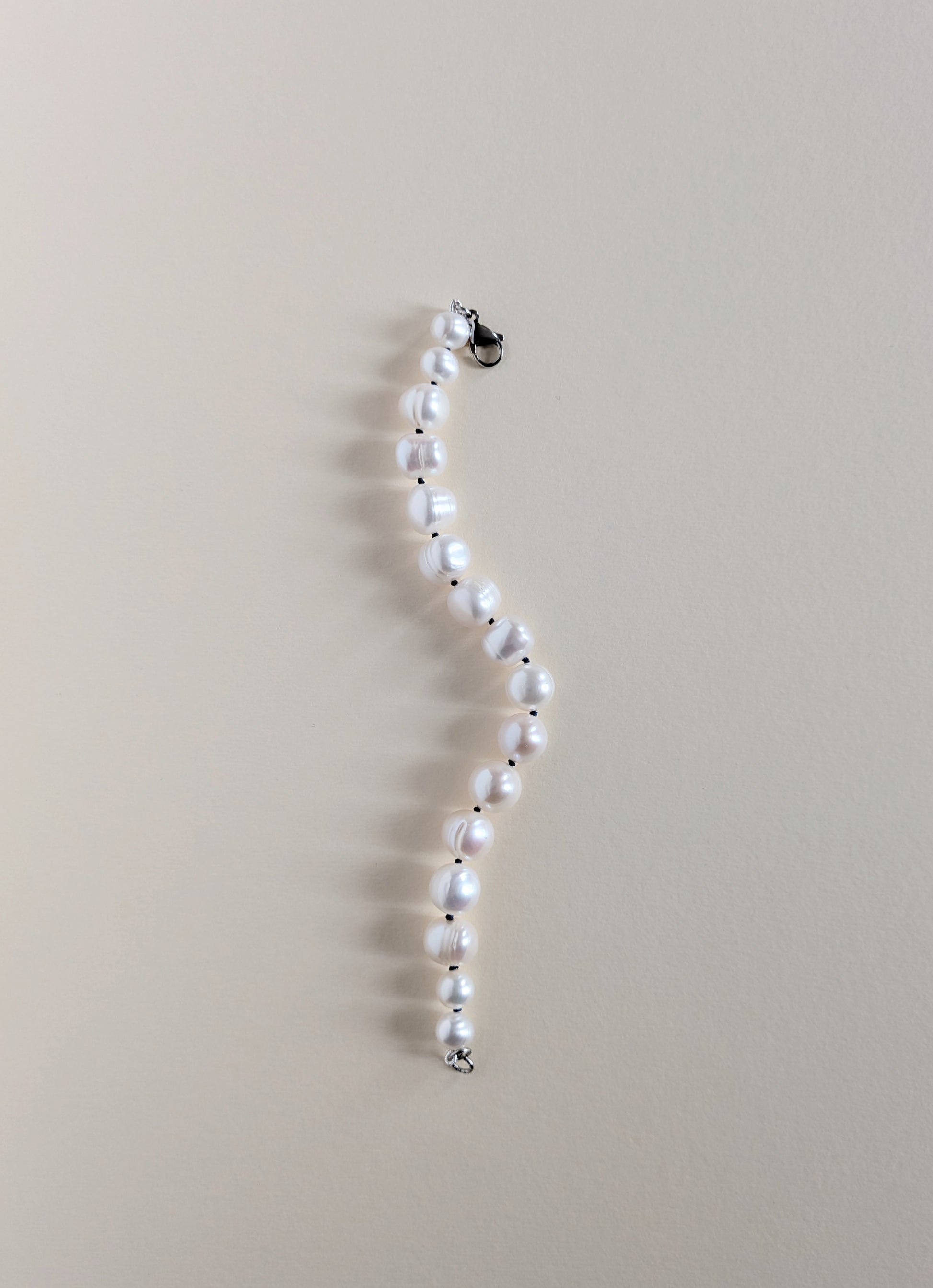 Pearl necklace on a beige background