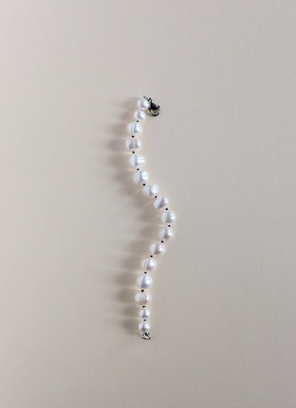 Pearl necklace on a beige background