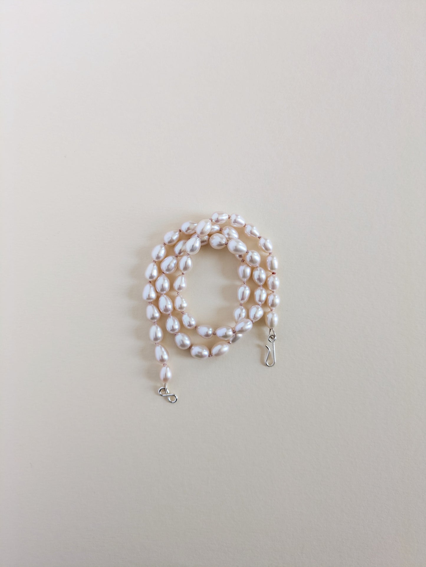 Pearl necklace on a light beige background