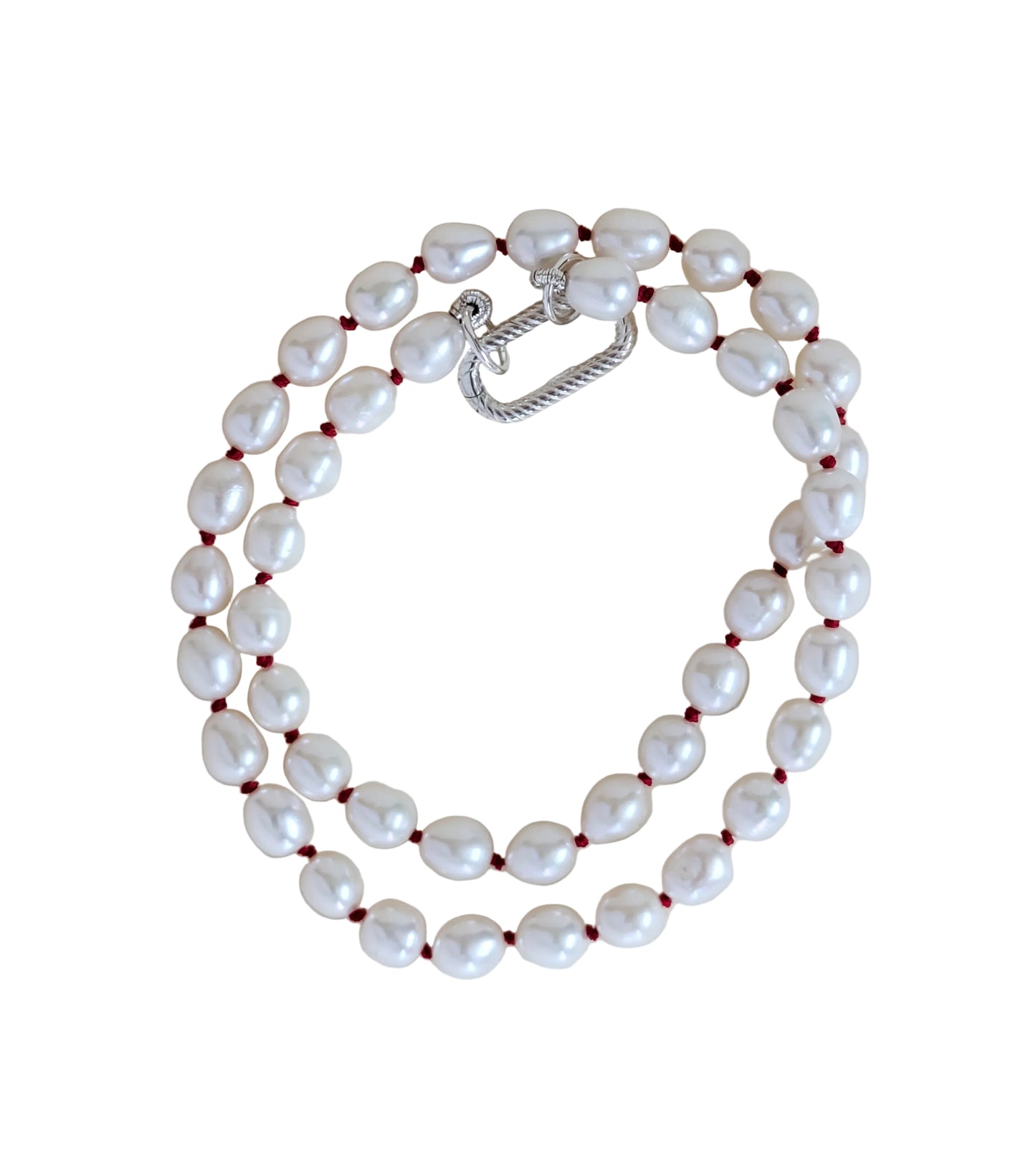 Pearl necklace with a silver clasp on a light beige background
