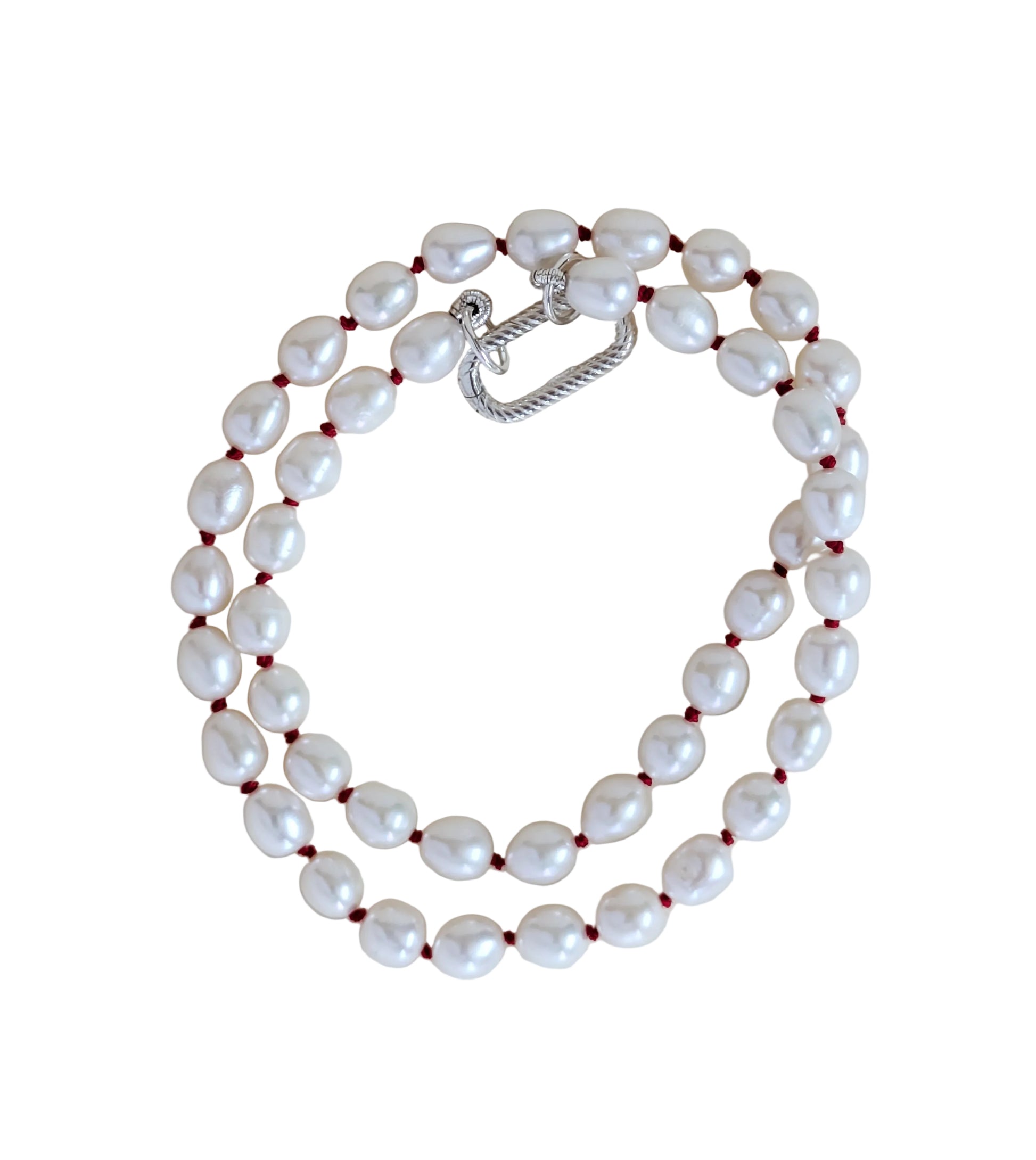 Pearl necklace with a silver clasp on a light beige background