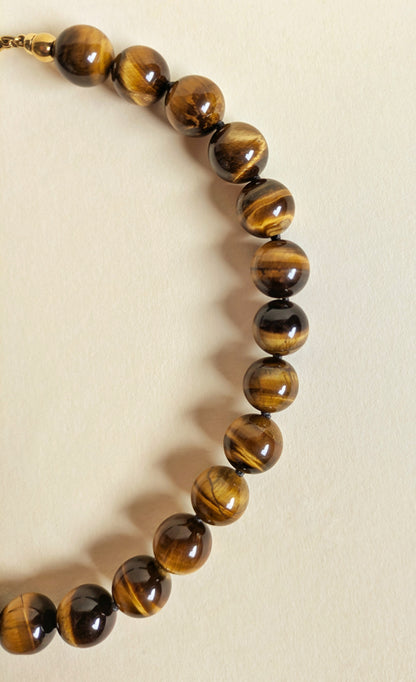 A detail of the tiger eye bead necklace.