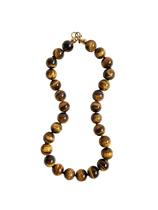 Tiger eye gemstone necklace on a white background.