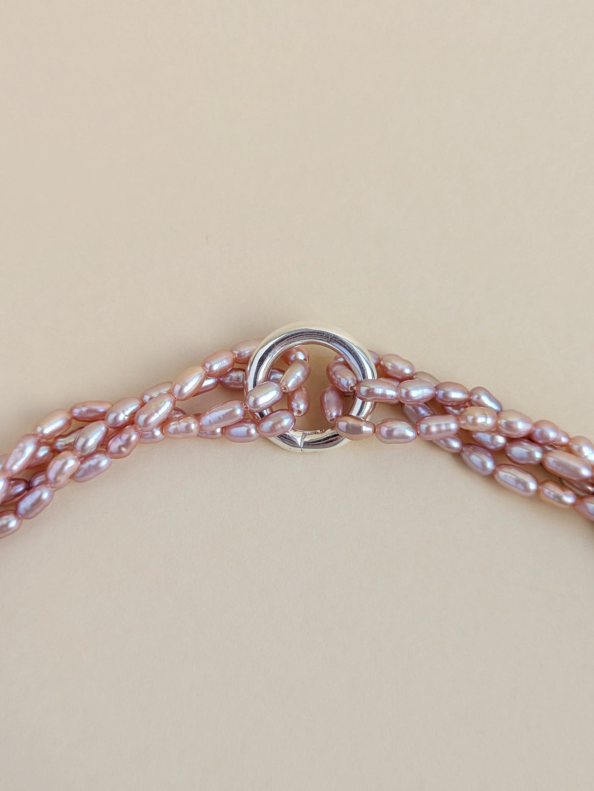 Close-up of the clasp and purple rice pearls.