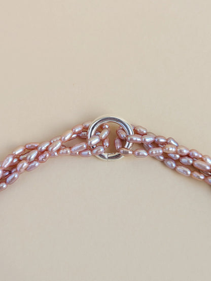 Close-up of the clasp and purple rice pearls.