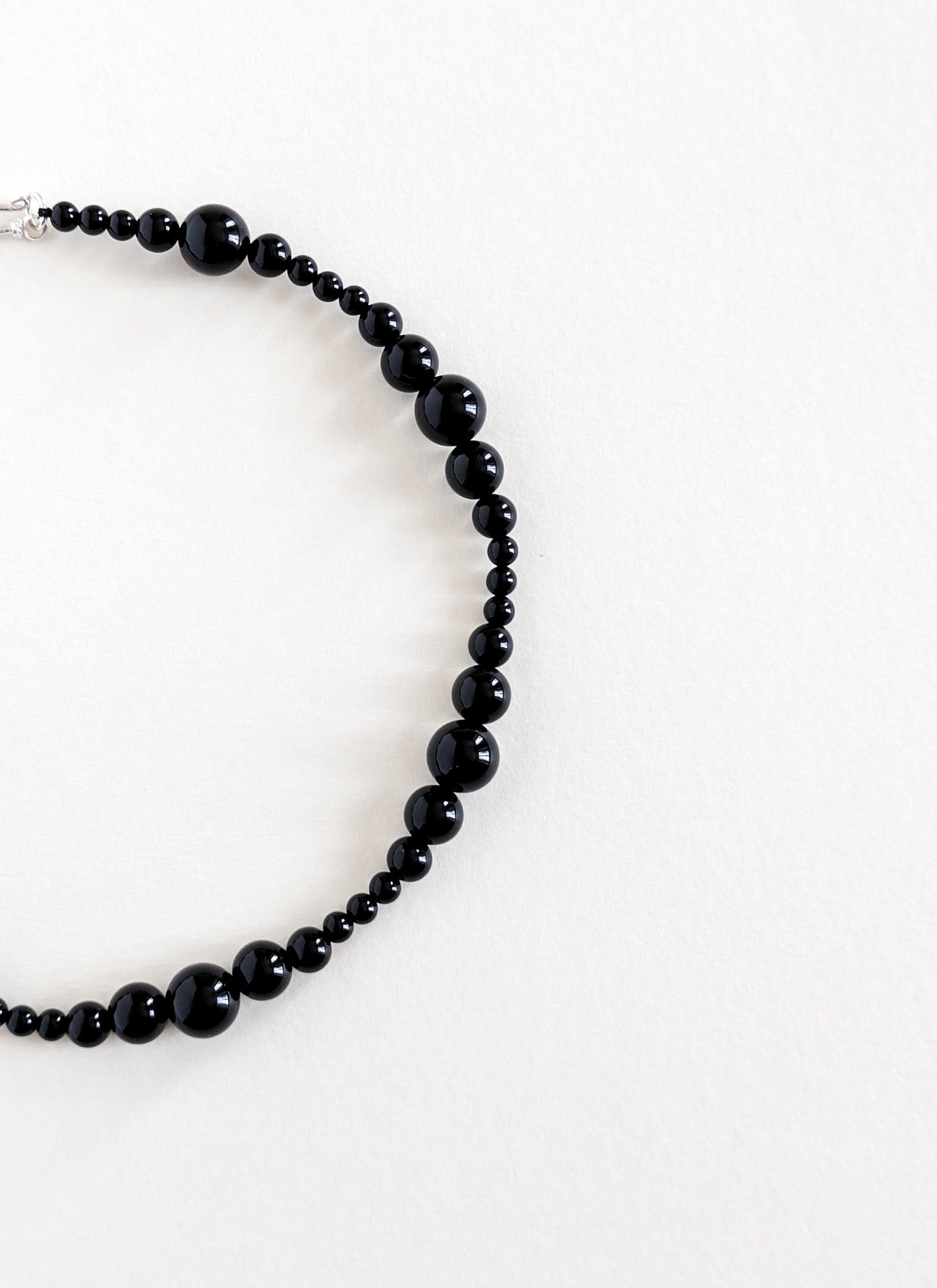 Black beaded necklace on a white background