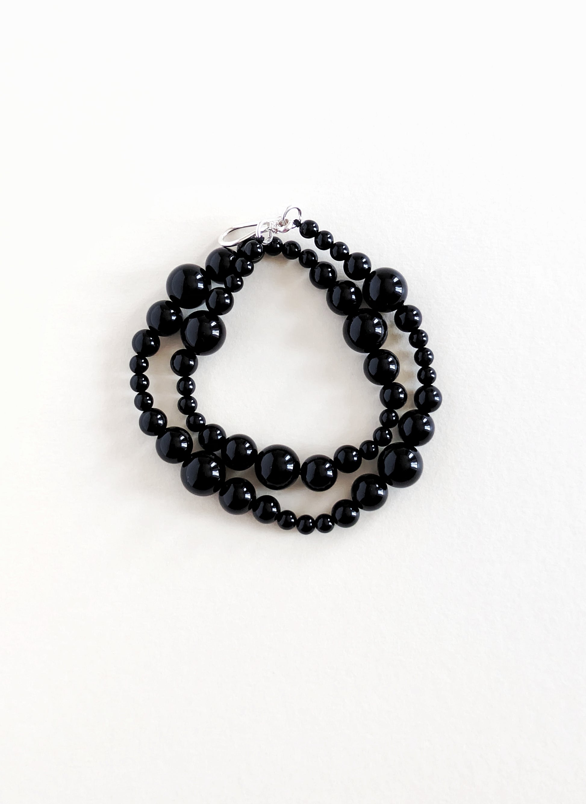 Black beaded bracelet on a white background