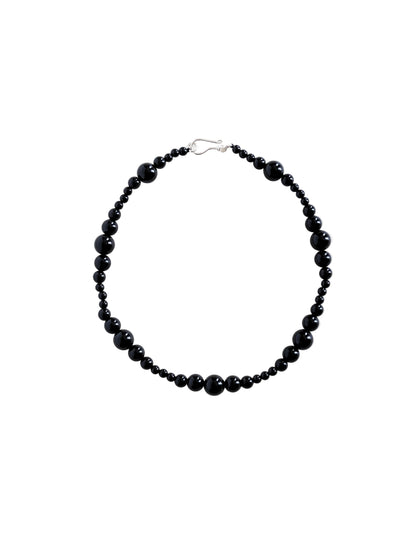 Black beaded necklace on a white background